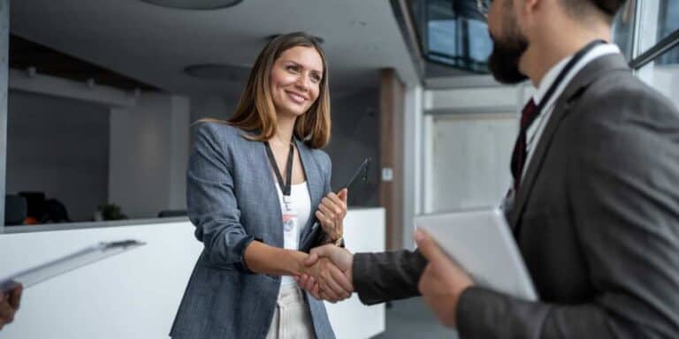 Image of a sales rep shaking hands with a prospect