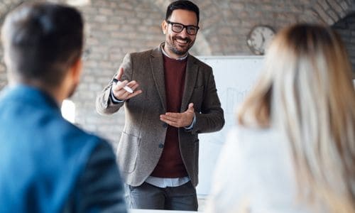 Fractional sales leader coaching two team members during a working session